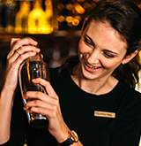 Bartender preparing a drink for Seasons 52 Happy Hour