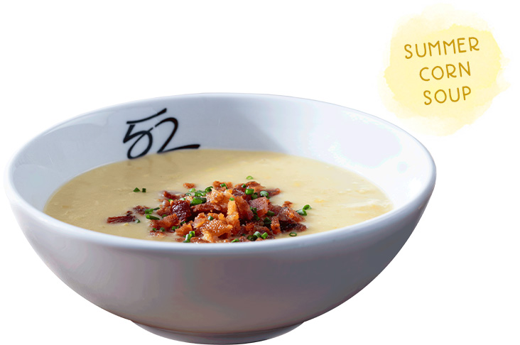 Summer Corn Soup topped with corn, bacon and chives, served with naan bread.