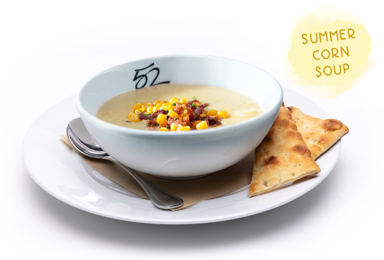 Summer Corn Soup topped with corn, bacon and chives, served with naan bread.